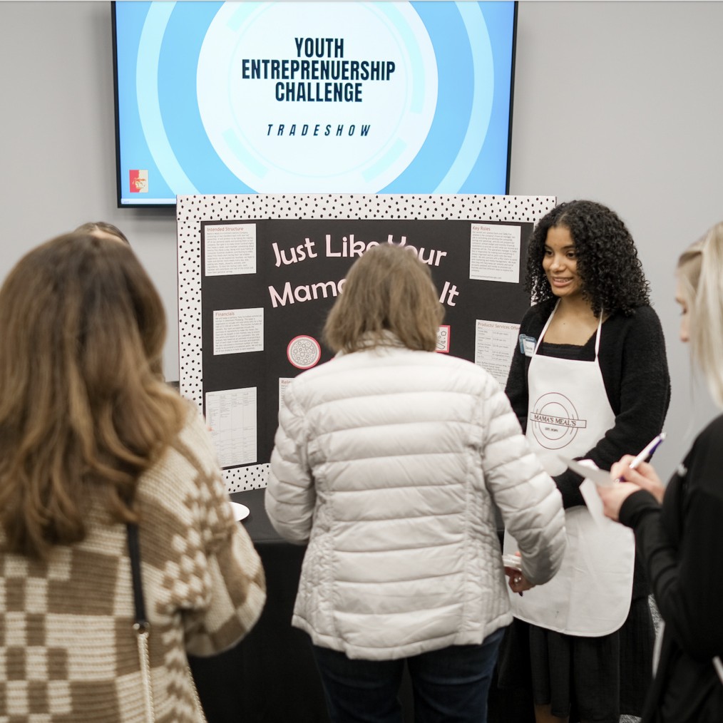 Photograph of student speaking to attendees at past Youth Entrepreneurship Challenge